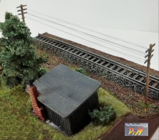 Overhead view of the N-Gauge train display base showing the rigging line between the telephone poles.