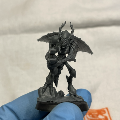 Assembled model of a Vespid Stingwing Warrior, unpainted grey plastic