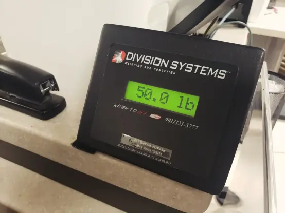 An airport baggage scale reading "50.0 lb"
