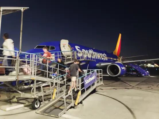 A Southwest Airlines plane boarding at a gate in Bob Hope Airport in Burbank, CA
