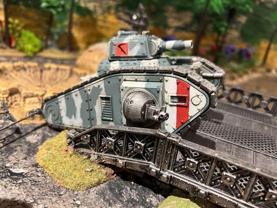 A camo painted tank model crossing a bridge.