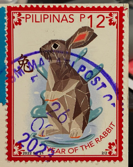 Canceled stamp from the Philippines celebrating the Year of the Rabbit. The rabbit is beautifully geometrical and the stamp is framed in red. 