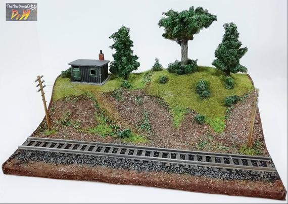 Model train display base, no train. Front view, high angle.