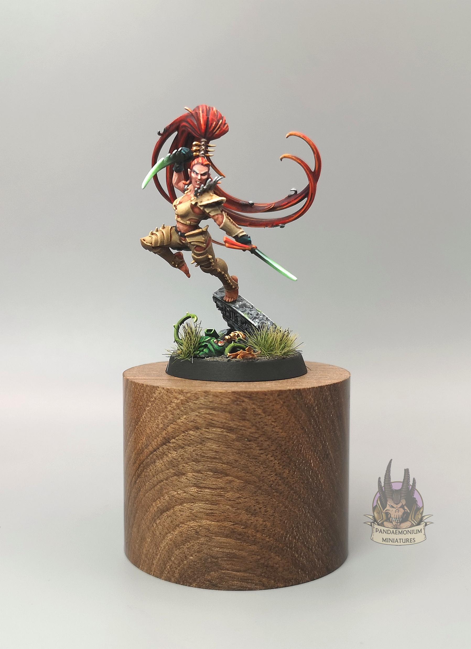 Lelith Hesperax in bone armour, wielding twin daggers with glowing green blades