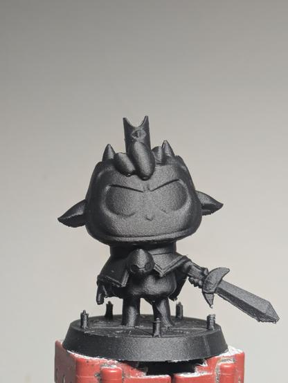 A printed figurine of an anthropomorphic lamb holding a sword.