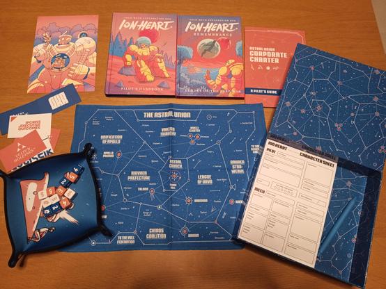 Several play materials for the Ion Heart rpg spread out on a wooden table.