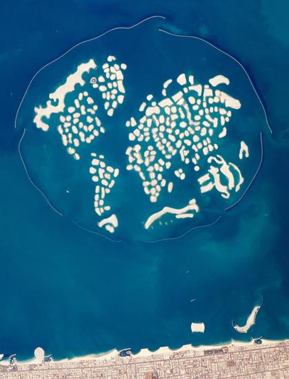 An aerial photograph of The World Islands, an artificial archipelago off the coast of Dubai, tiny, private islets arranged in what’s very roughly a world map.
