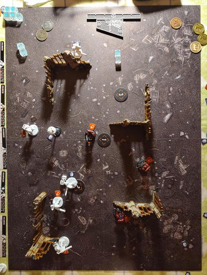 Bird's eye view of a kill team battlefield with white unpainted stealth battlesuits and blood angels angels of death scattered around.