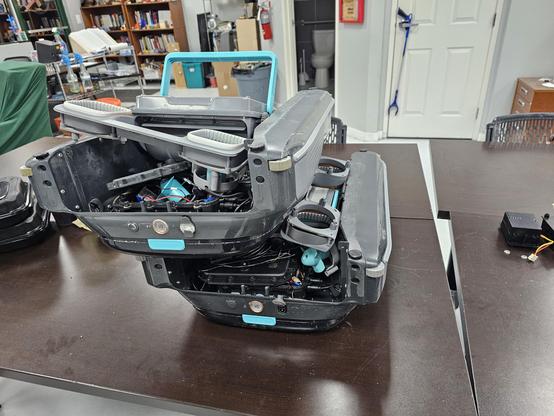 Two skimmer pool robots that have been disassembled and are now stacked on top of each other. Honestly, it's basically a pile of mechanical and electronic junk jumbled together and not working anymore.