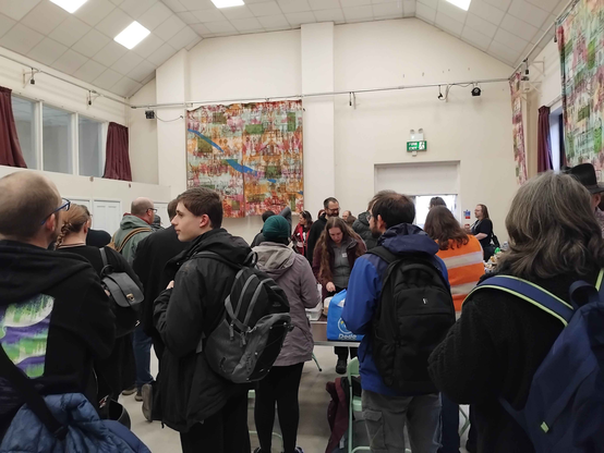 Crowd gathering for sign-ups at the morning of the convention, seen from the back of the room