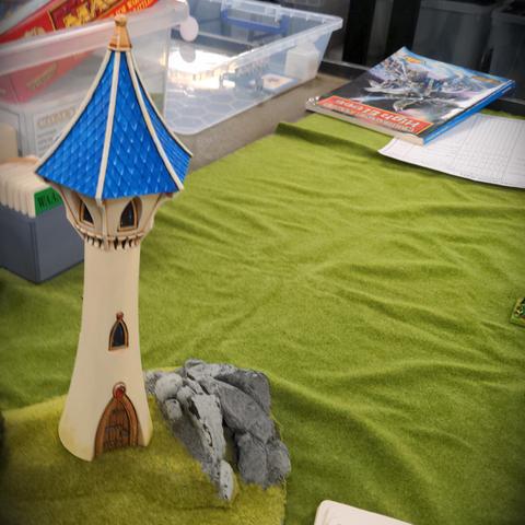 An elven tower stands on a hill to the side of the battlefield, had it not been for the sentry who warned them the nobles would have been slaughtered at there dinner table by the horde of greenskins