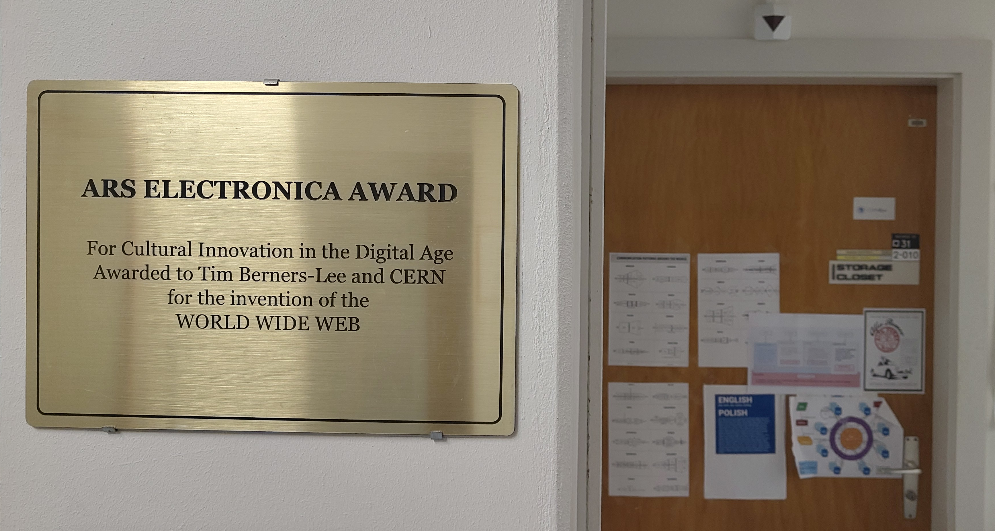 Plaque attached to the wall outside Tim Berners-Lee's former office in CERN Building 31. The text reads: ARS Electronica Award for Cultural Innovation in the Digital Age awarded to Tim Berners-Lee and CERN for the invention of the WORLD WIDE WEB.