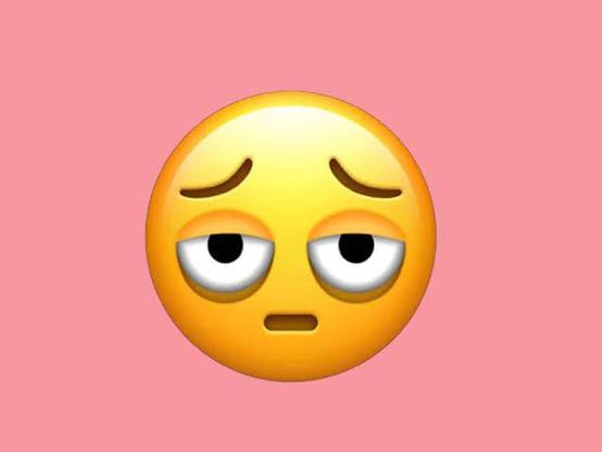 A "tired face" emoji: a yellow face with a small, passive mouth and heavy-lidded eyes, dark bags hanging beneath them.