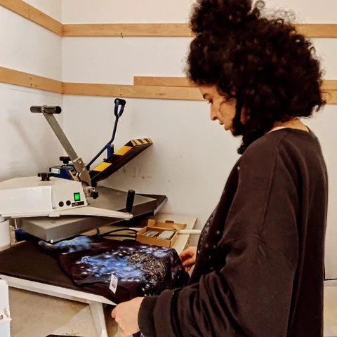 Niloo arranging a t shirt for pressing on the new heat press