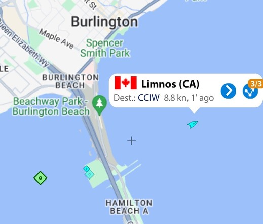 A screenshot of a map of western lake Ontario with city of Burlington on the north shore. A ship is marked with a blue triangle with a label of Limnos (CA) with a Canadian flag. Dest. CCIW 8.8 kn. From MarineTraffic app.