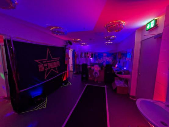 The Toilet washing room. On the left the 18c3 logo with red star and keyboard. The light is a mix of blue and red resulting in purple