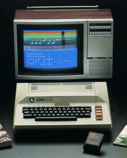 Atari 800 with a color TV and a BASIC cartridge. The color TV looks silver and wood, shows some musical notes. The overall colors are somehow non-boring beige, gray, black.