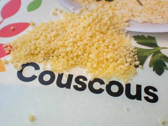 Close-up of a pile of yellow couscous that clearly shows that they are just little crumbles of pasta, not small seeds.