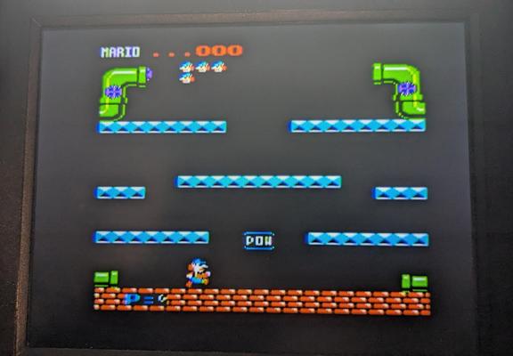 Mario Bros video game, a platformer for 8 but computers and game consoles. This version is for the Apple II but the image is fuzzy with some color fringing.