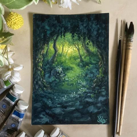 A photo of a portrait-format painting, placed on a tiled surface and surrounded by paint brushes, paint tubes, and artificial plants for decoration. The painting features a portal-like opening made of rock and trees into a forest flooded with soft, yellow light. A few rocky spirits sleep among the greenery, and a few tiny white flowers grow around the portal.