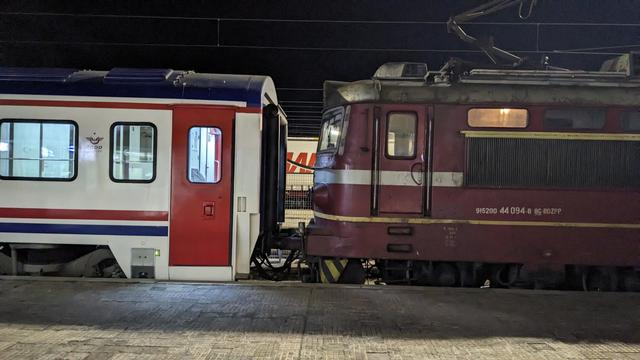 A BDŽ locomotive coupled to a TCDD sleeper carriage at night time.
