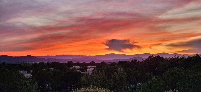 Sunsets are back. This one offers us intense orange, red and yellow, with a small dark cloud in the middle.