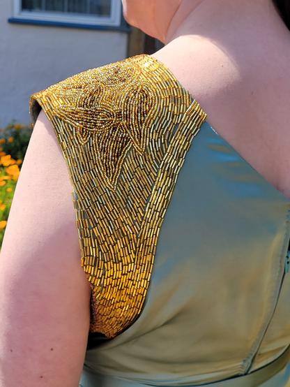 A close up of the beadwork in the sun, being worn. The beads just sparkle in the sunlight.