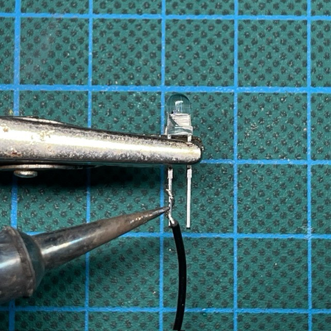 Close up of LED being soldered.