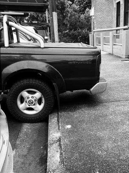 Car grabs rare footpath and pollutes al fresco air as well. Bellingen