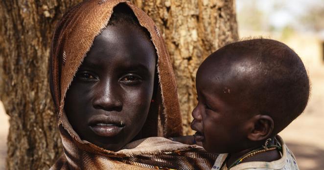 Roda Abdullay, 14, holds her 8-month-old brother who is suffering from malnutrition. Roda Abdullay, 14, holds her 8-month-old brother who is suffering from malnutrition.