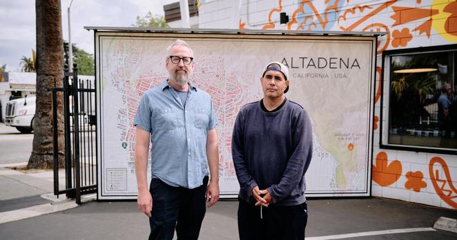 Noel McCarthy and Randy Clement in front of the map McCarthy made displaying the extent of the Eaton Fire in the parking lot of Clement's business, the Good Neighbor Bar on Friday, March 27, 2025. (Marcus Ubungen / For The Times) Noel McCarthy and Randy Clement in front of the map McCarthy made displaying the extent of the Eaton Fire in the parking lot of Clement's business, the Good Neighbor Bar on Friday, March 27, 2025. (Marcus Ubungen / For The Times)