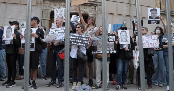Demonstrators holding up placards