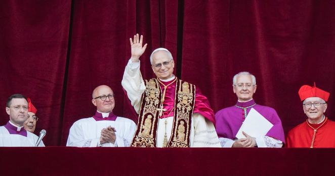 Pope Leo XIV, in his first public appearance after he was elected, waves from the balcony of St Peter’s Basilica in the Vatican. Photograph: Gianni Cipriano/The New York Times                      