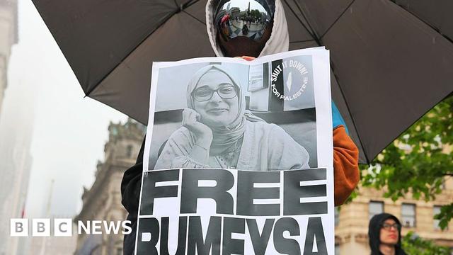 Someone holds a sign in protest with Rumeysa Ozturk's face
