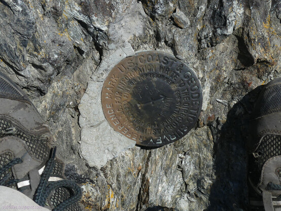 Two shoes only slightly poked with holes from the tough trail the day before bookend a metal disk with an arrow and the writing "Horse Ride no 1 1961" as well as standard writing for a USCGS reference mark.