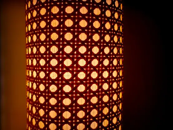 Warm, dark, and moody off-center photo of a solihiya-weave paper lantern