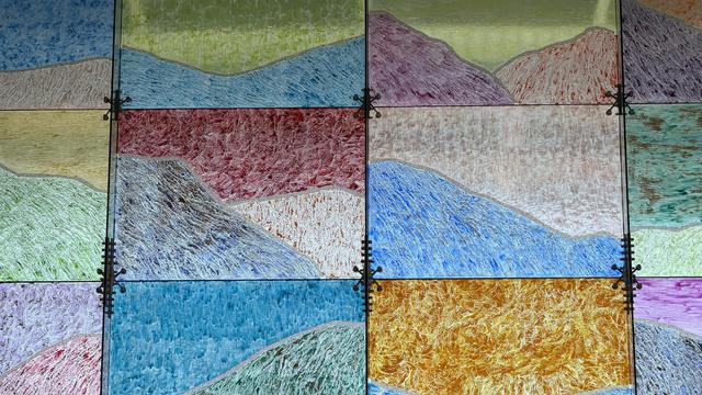 Portion of window display at Milpitas Station, subdivided into multiple sections, each colored distinctly with feathery patterns