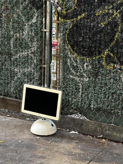 an abandoned imac g4 on the street