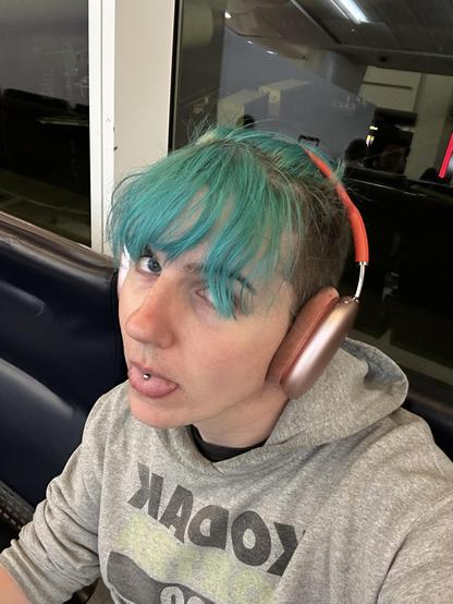 selfie, i'm wearing headphones and sitting in an airport terminal