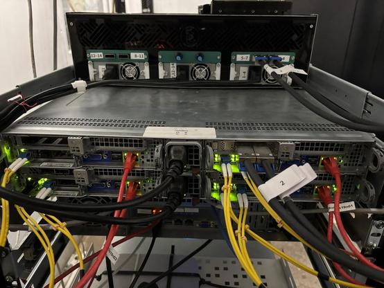 a 2U supermicro blade server - with four nodes (2x EPYC 7001 series CPU, 128GB of DDR4). Above it, an experimental multi-node SAS hard drive chassis made by yours truly. Lots of cables.