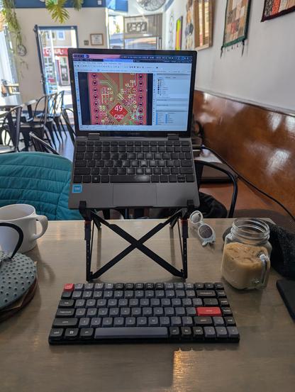 A photo of my cafe CAD setup with my mini laptop on a stand over my keyboard