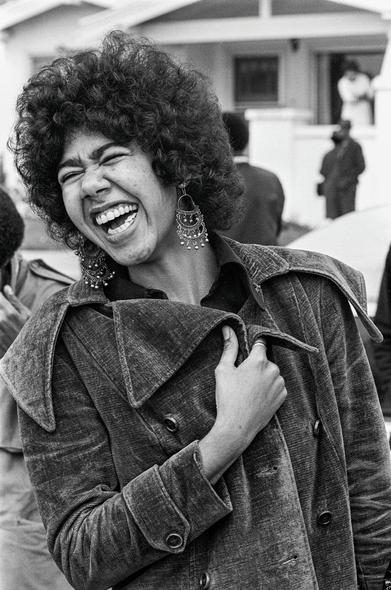 "Black Panther member and book co-author Ericka Huggins laughs with comrades after the Black Community Survival Conference. She served in the Los Angeles, New Haven, and Oakland offices of the party."