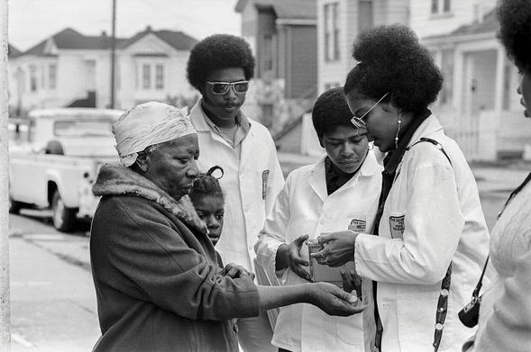 "Black Panther Adrienne Humphrey tests a woman for Sickle Cell Anemia during Bobby Seale’s campaign for mayor of Oakland."