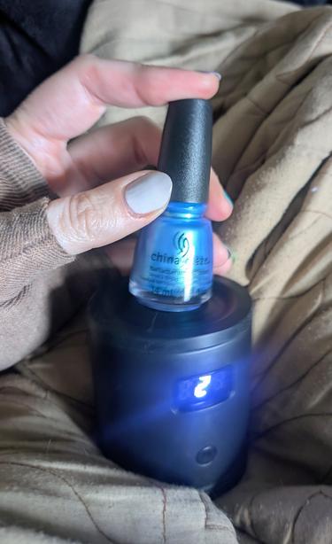 Another shot showing my white polished thumb holding a polish bottle on my liquid agitator