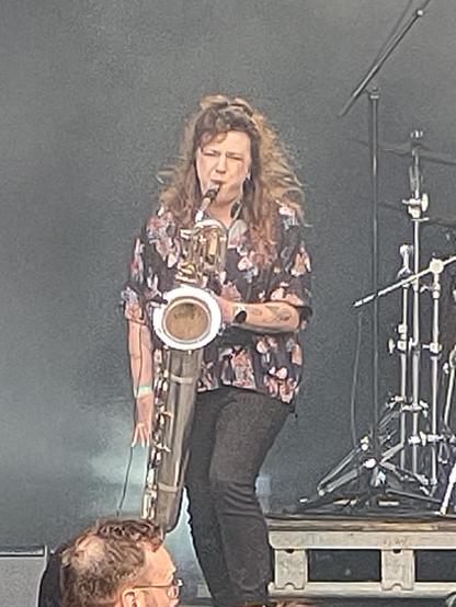 Monia Muc playing a enormous (baritone) saxophone