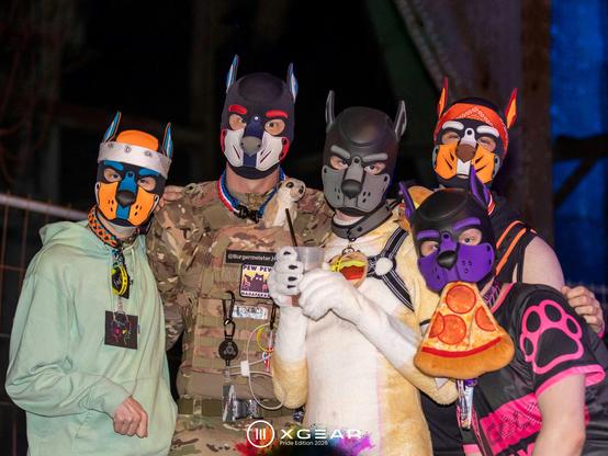 HeRO, Lou, Taiyo, Danzo & Aki outside at night in front of the steel structure of a mining rig during XGear Pride Edition