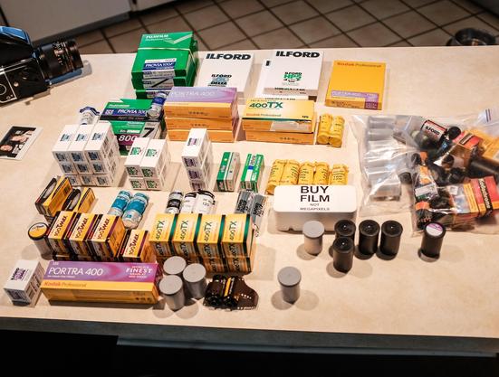My countertop covered in rolls and boxes of film of all kinds.