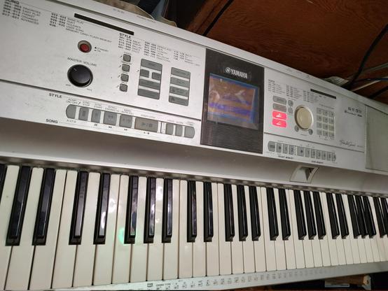 photo of a somewhat weathered Yamaha DGX-505 "PortableGrand" digital piano