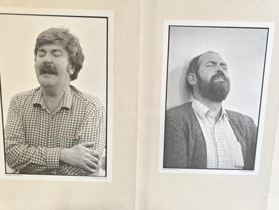 Two black and white photos on a wall of trad singers who probably aren't having an orgasm, but if you're juvenile enough, you can say they are