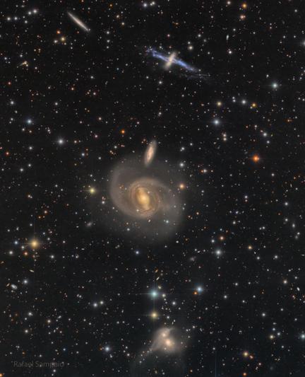 A dark starfield shows three pairs of galaxies. One pair near the top, one near the middle, and one near the bottom.